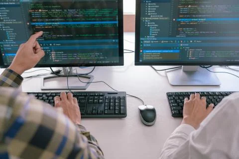 Young startup Programmers Sitting At Desks Working On Computers screen for De 库存照片