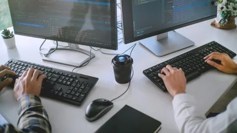 Young startup Programmers Sitting At Desks Working On Computers screen for De 스톡 사진
