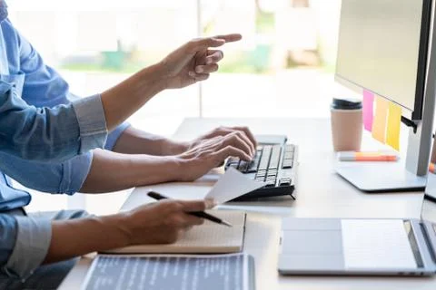 Young startup Programmers Sitting At Desks Working On Computers screen for De 스톡 사진