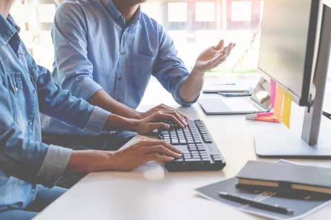 Young startup Programmers Sitting At Desks Working On Computers screen for De 스톡 사진