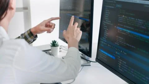 Young startup Programmers Sitting At Desks Working On Computers screen for De 写真素材