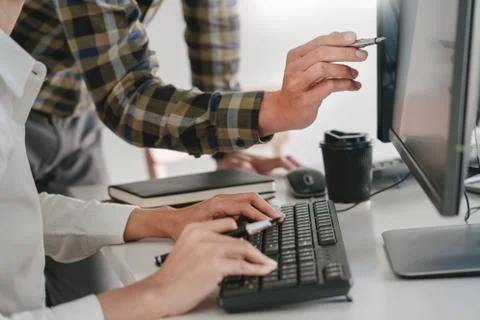 Young startup Programmers Sitting At Desks Working On Computers screen for De Stockfoto's