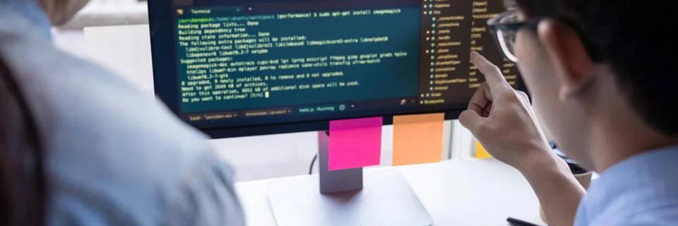 Young startup Programmers Sitting At Desks Working On Computers screen for... Stock-Fotos