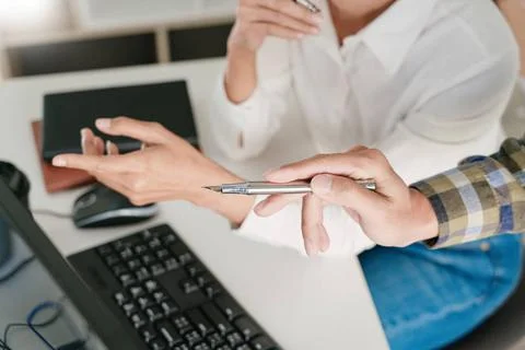 Young startup Programmers Sitting At Desks Working On Computers screen for... Stock-Fotos