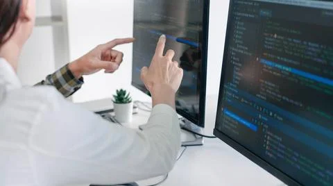 Young startup Programmers Sitting At Desks Working On Computers screen for... 写真素材
