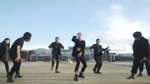 Young STREET PERFORMER performing on the street. Seven chinese teenagers danc Stock Footage 121934566