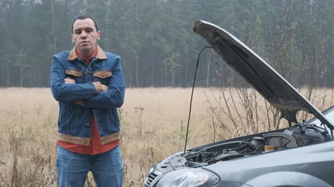 Young stressed man having trouble with his broken car Stock Footage 144064344