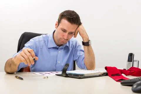 Young stressed manager analyzing some charts 스톡 사진