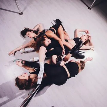 Young striptease dancer moving in high heels shoes on stage Pole dancing. Stock Photos