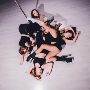 Young striptease dancer moving in high heels shoes on stage Pole dancing. Stock Photos