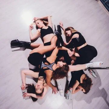 Young striptease dancer moving in high heels shoes on stage Pole dancing. Stock Photos