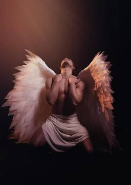Young strong angel with white wings from heaven. Angel with muscular body. Stock Photos