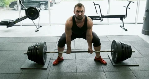 Young strong athlete does exercise with barbell. Slow motion Stock Footage 116974285