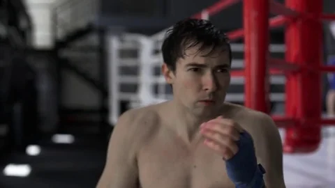 Young strong boxer training in a gym Stock Footage 76500446