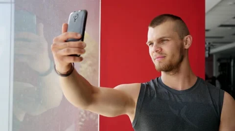 Young strong guy in gym doing selfie photo for social media instagram Stock Footage 65428783