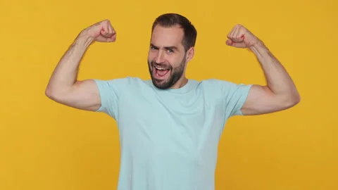 Young strong man 20s years old in basic casual blue t-shirt isolated on yellow Stock Footage 148283039