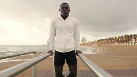 Young strong man doing dips on parallel bars Stock Footage 288717421