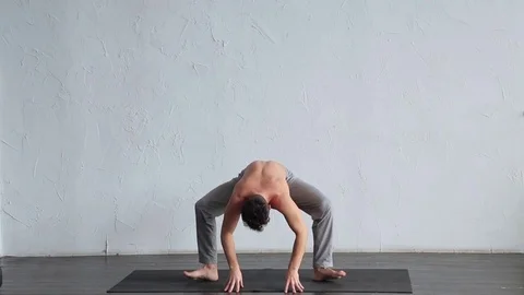 A young strong man doing yoga exercises. Stock Footage 71239802