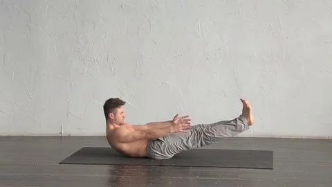 A young strong man doing yoga exercises. Studio shot Stock Footage 71240525