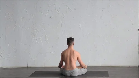 A young strong man doing yoga exercises. Studio shot Stock Footage 71240757