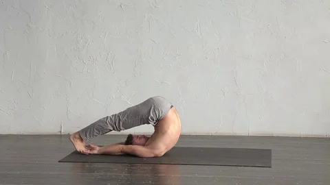A young strong man doing yoga exercises. Studio shot Stock Footage 71240859