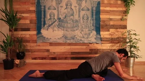 A young strong man doing yoga exercises Stock Footage 82968346