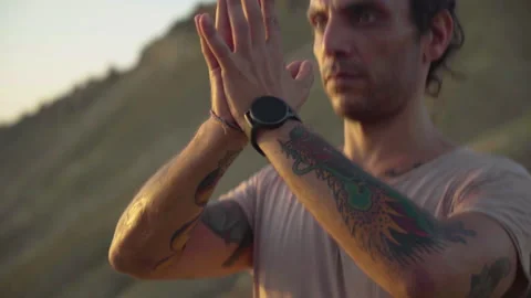 Young Strong Man Doing Yoga at Sunset Camera Follows Hands Stock Footage