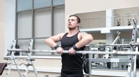 Young strong man hard train muscles in gym Stock Footage 62562196