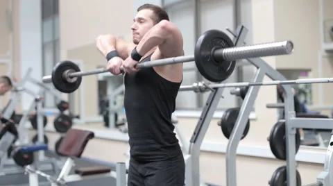 Young strong man hard train muscles in gym Stock Footage 62562216