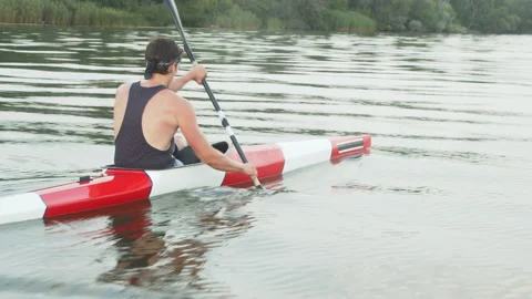 Young strong man kayaking fast Stock Footage 135864660