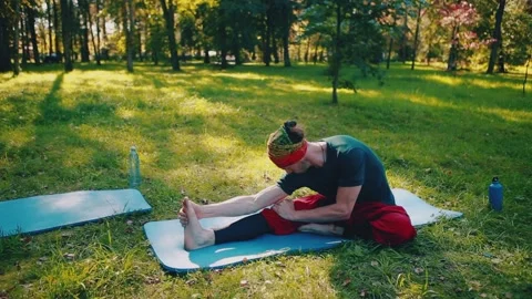 Young strong man performs yoga exercises, stretching the twine. Stock Footage 149751455