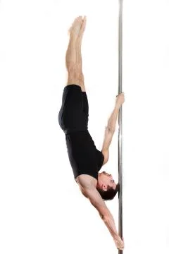 Young strong pole dancer smiling man in black clothes on pylon. White backgro Stock Photos