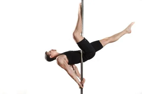 Young strong pole dancer smiling man in black clothes on pylon. White backgro Stock Photos