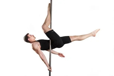 Young strong pole dancer smiling man in black clothes on pylon. White backgro Stock Photos
