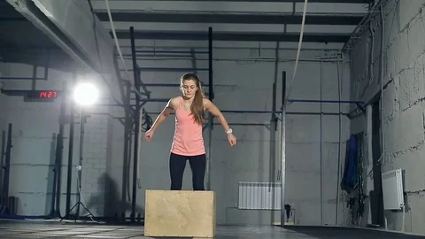 Young strong woman with perfect fitness body in sportswear doing set of box Stock Footage