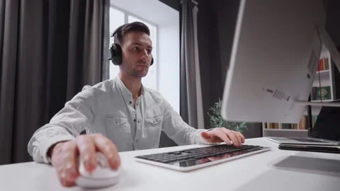 Young student is actively studying the subject remotely. Sits at the computer Stock Footage 160557142