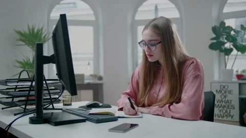 Young Student Adjust Notes While Looking On Monitor. Studying on Distance. 스톡 동영상 131552827