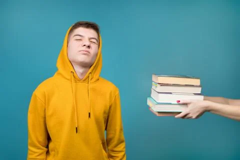 Young student and a stack of books Foto stock