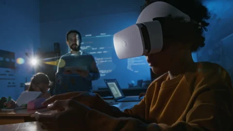 Young Student in AR Headset Browsing through Virtual Manual at Coding Lesson Video stock 307065743
