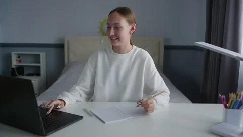 Young student attending online class and taking notes Stock Footage 315174055