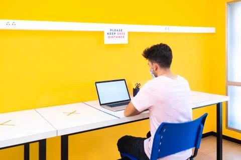 Young student boy doing his homework on the computer at school. Concept of go Stock Photos
