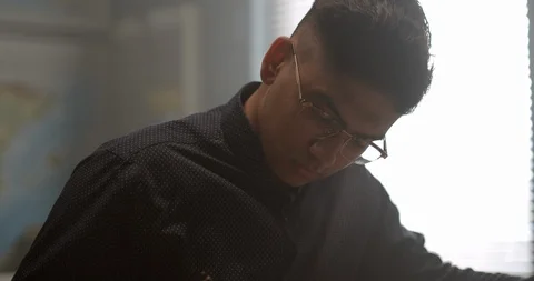 Young student in classroom writes in notebook preparing for test Vidéo 118141443