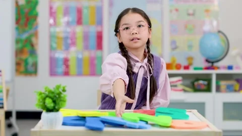 Young Student Demonstrates Math Counting in Classroom Setting Stock Footage 321450286