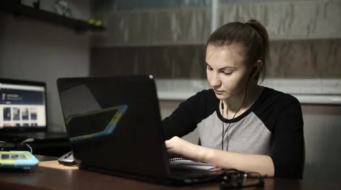 Young student does his homework for a laptop at night Video stock 60051830