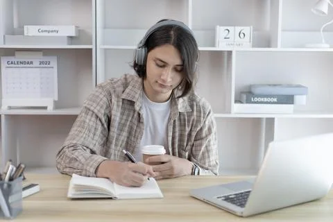 Young student does his homework and is broadcast live on his laptop during th Stock-Fotos