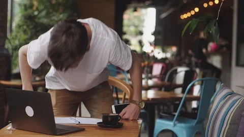Young student doing homework in cafe, freelancer using pencil to draw on paper 動画素材 112594468