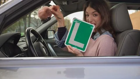 Young student driver showing her learner permit Stock Photos