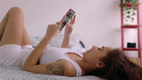 Young student girl using mobile phone in room Stock Footage 233727698