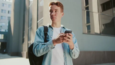 Young student handsome man with red hair stand near university or office Stock Footage 142049950
