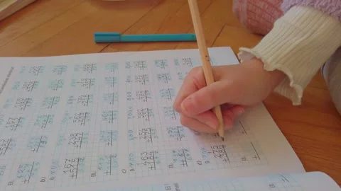 A young student huffs in frustration, erasing a mistake for the third time Stock Footage 326021550